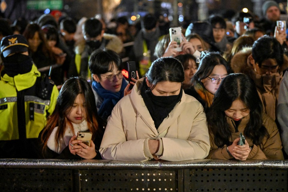 Watch haunting moment mourning South Korea marks New Year with SILENT crowds after plane disaster and ‘coup’ drama